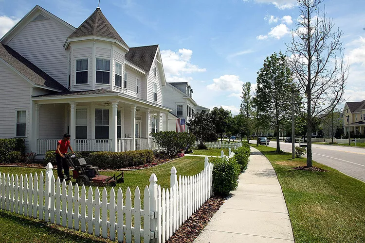 Charming streetscape of homes in Celebration Florida with tree lined streets and front porches
