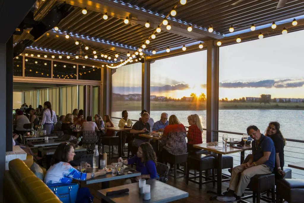 Sunset waterfront dining at Lake Nona near Lake Nona Estates luxury homes in southeast Orlando Florida