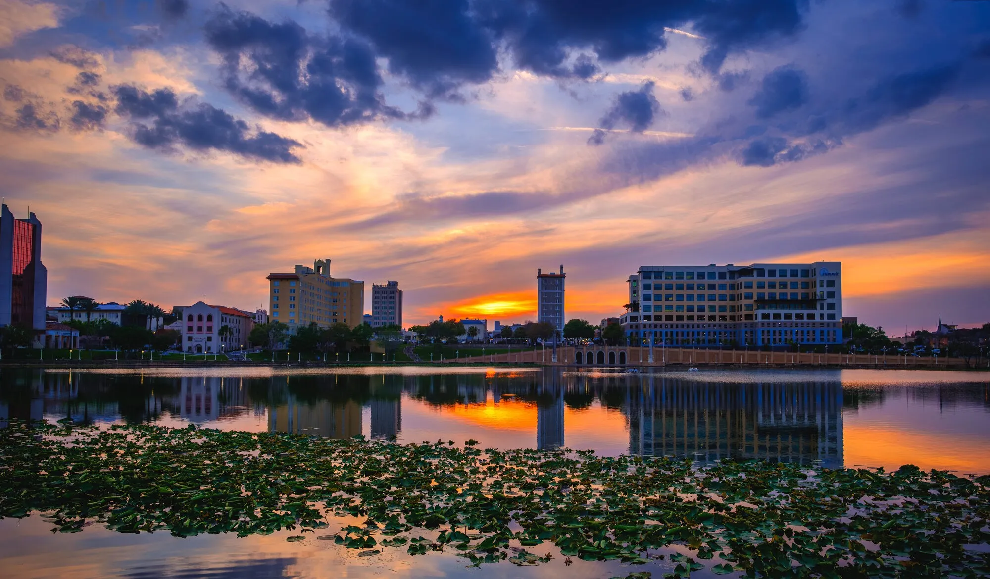 Sunset over Lake Mirror in Lakeland Florida with the promenade and downtown skyline